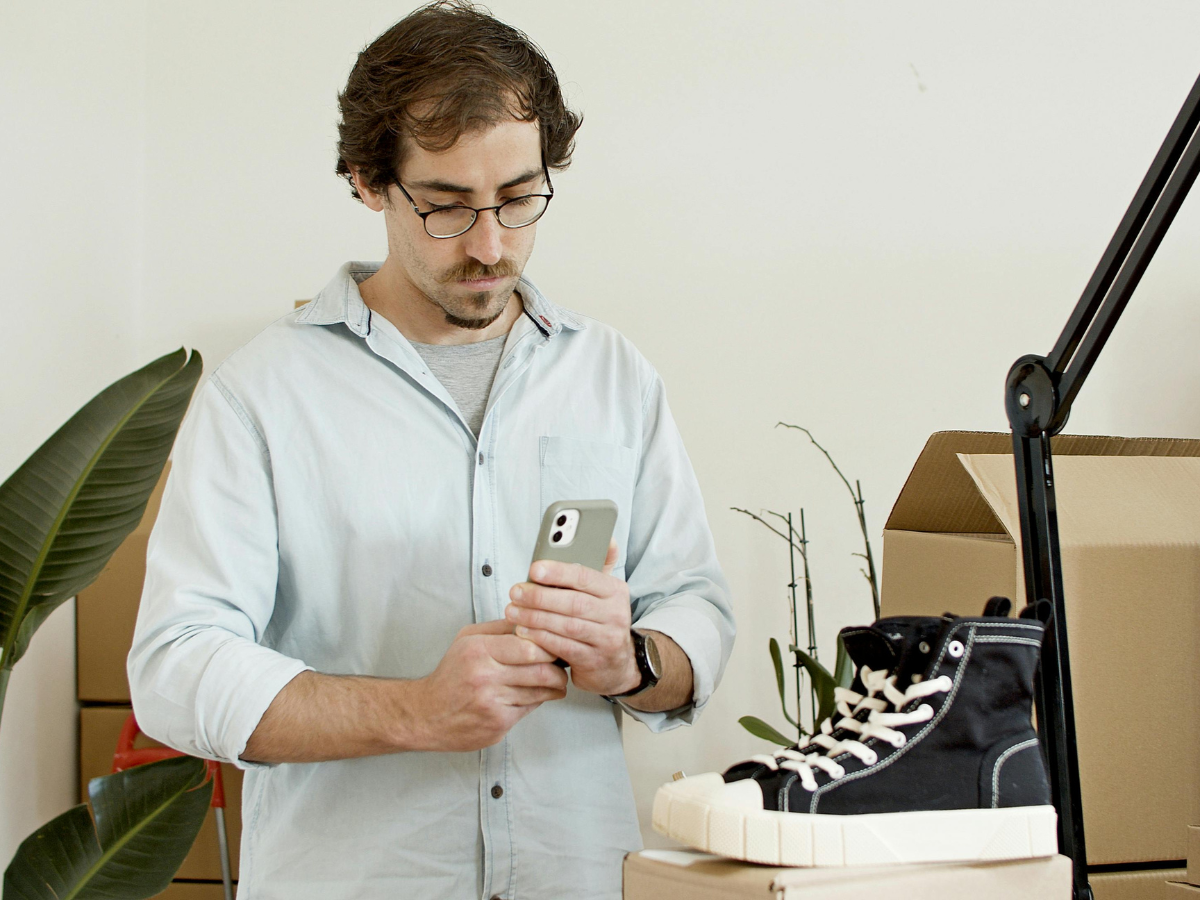 Man in White Dress Shirt Holding Iphone