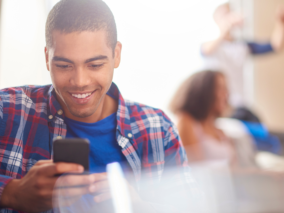 a young man looking at his cell phone